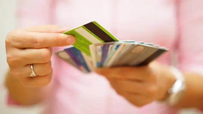 woman choose one credit card from many, concept of  credit card debt,.