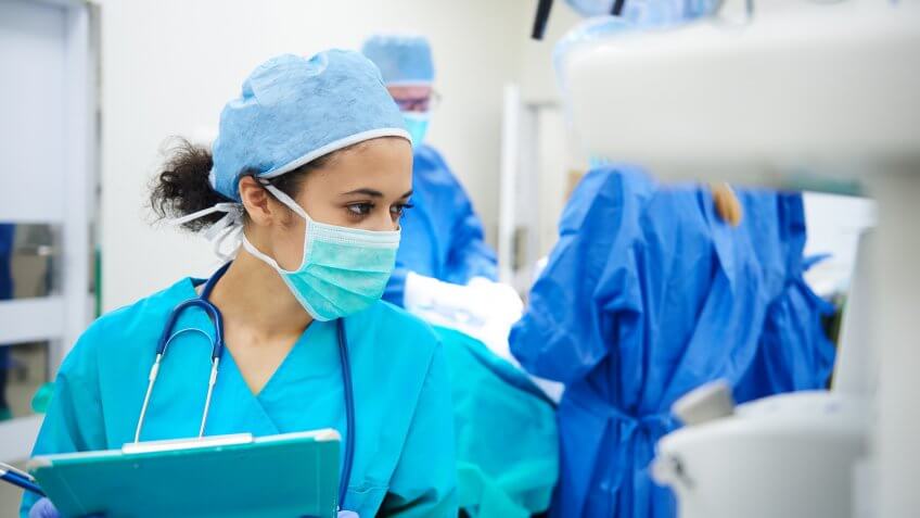 Female anaesthesiologist writing the updates.