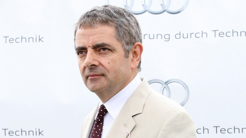 CHICHESTER, ENGLAND - AUGUST 02: Rowan Atkinson gives an award at ladies day at 'Glorious Goodwood' at Goodwood on August 2, 2012 in Chichester, England.