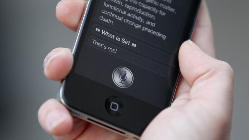 LONDON, ENGLAND - OCTOBER 14: A man uses 'Siri' on the new iPhone 4S after being one of the first customers in the Apple store in Covent Garden on October 14, 2011 in London, England.