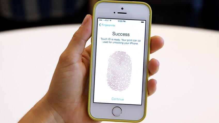 CUPERTINO, CA - SEPTEMBER 10: The new iPhone 5S with fingerprint technology is displayed during an Apple product announcement at the Apple campus on September 10, 2013 in Cupertino, California.