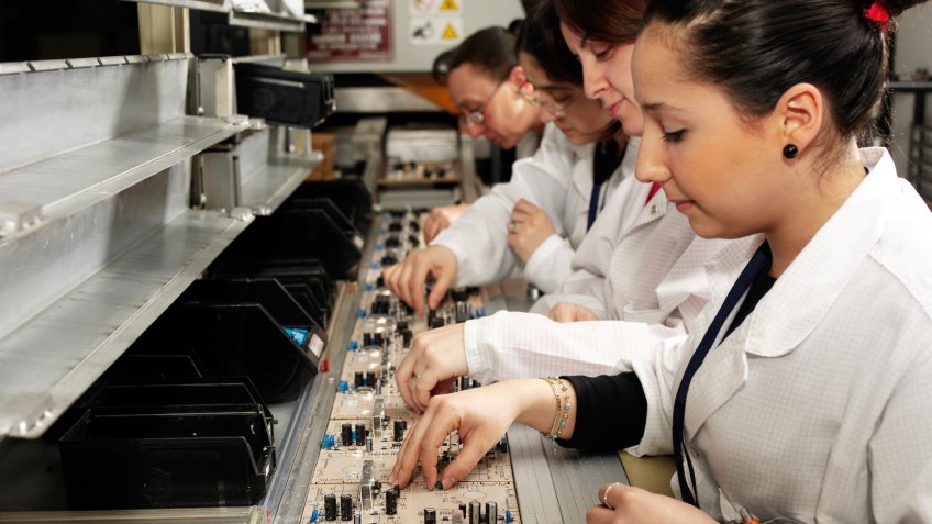 female workers with circuit boards.