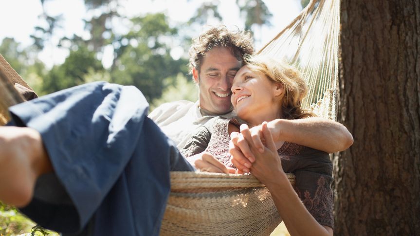 Couple sitting in hammock.