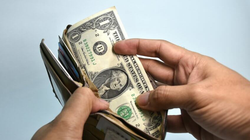 pulling cash from a wallet