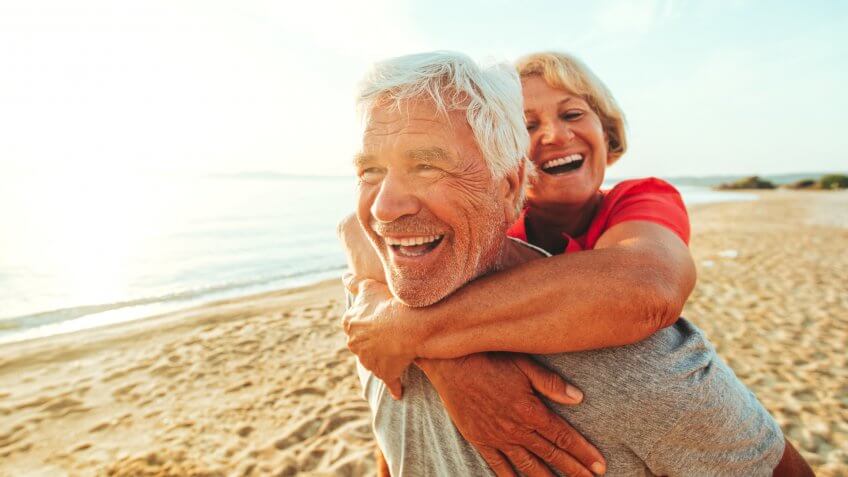 A senior couple seen having fun at the beach on a nice day.
