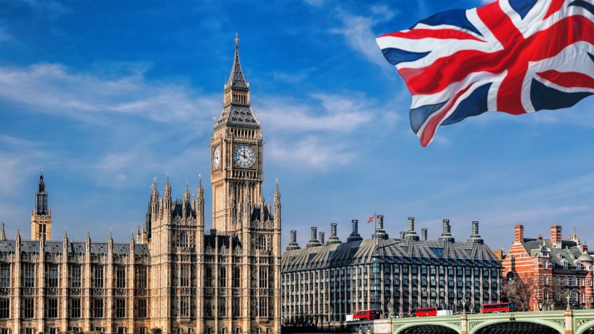 Big Ben with flag of England in London, UK.