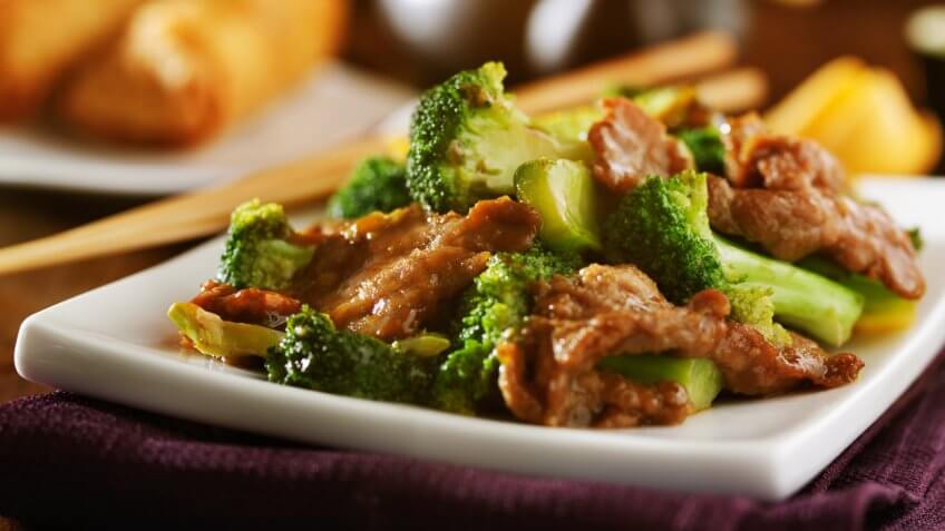 beef and broccoli chinese stirfry on white plate.