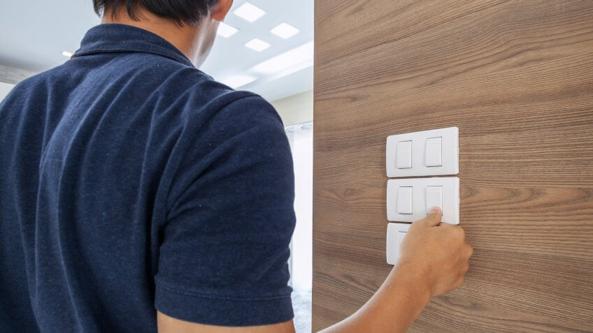 men switching off the light, saving concept.