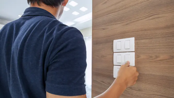 men switching off the light, saving concept.