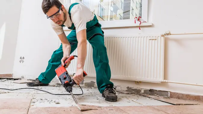 Demolition of old tiles with jackhammer.