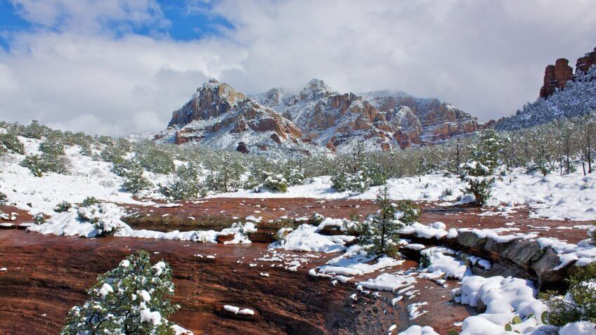 a rare snowstorm covers the red rock country of sedona arizona in white.