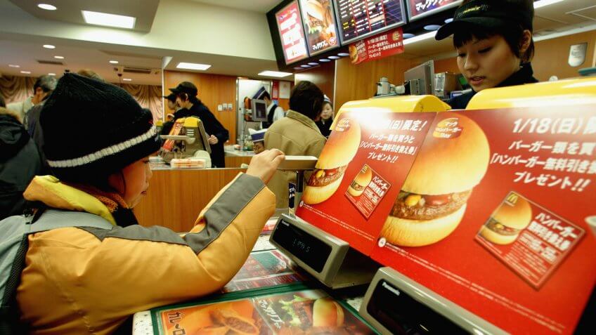 TOKYO - JANUARY 18: A Customer makes a purchase in a McDonalds January 18, 2004 in Tokyo, Japan.