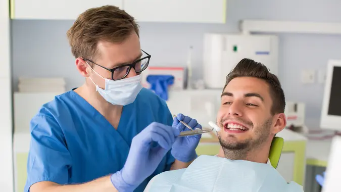 A dental hygienist doing a routine clean up on a patient.