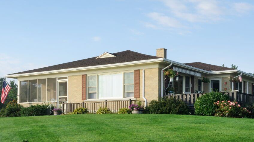 Classic american bungalow from the 60's or 70's with freshly cut lawn.