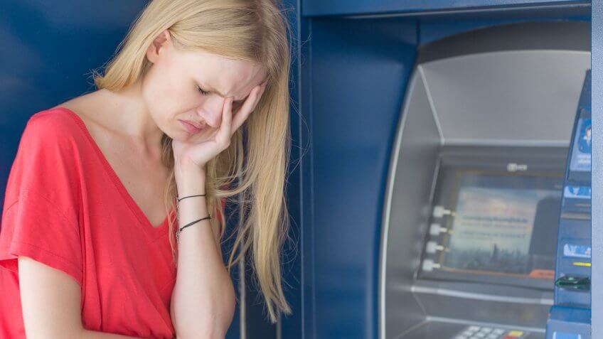 woman sad at ATM