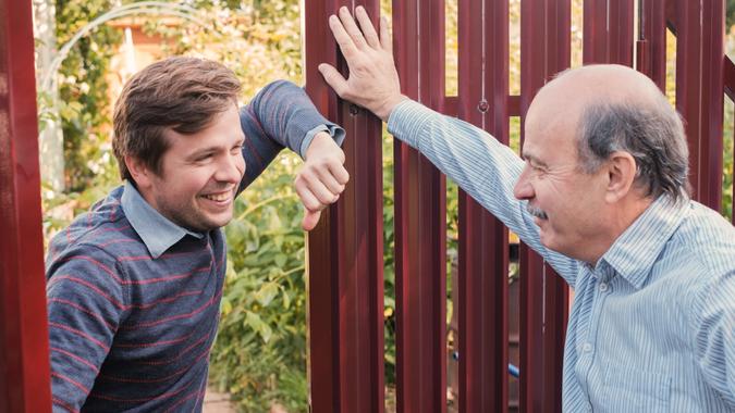 two farmers takling to each other on sunny day.