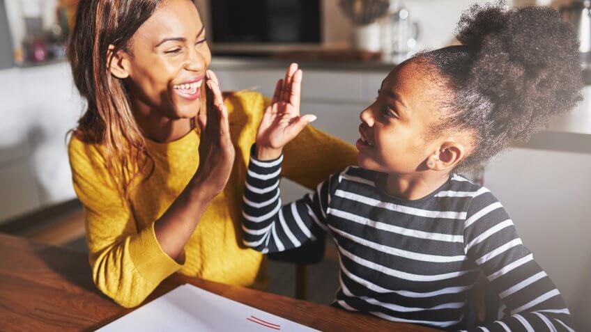 Learning to calculate, high five success, mother and child.