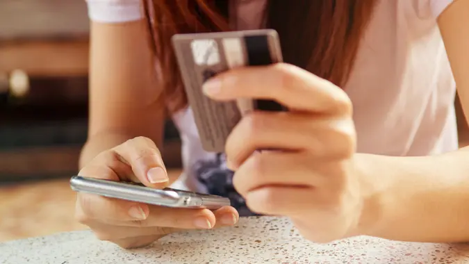 Woman is making online shopping with mobile phone.