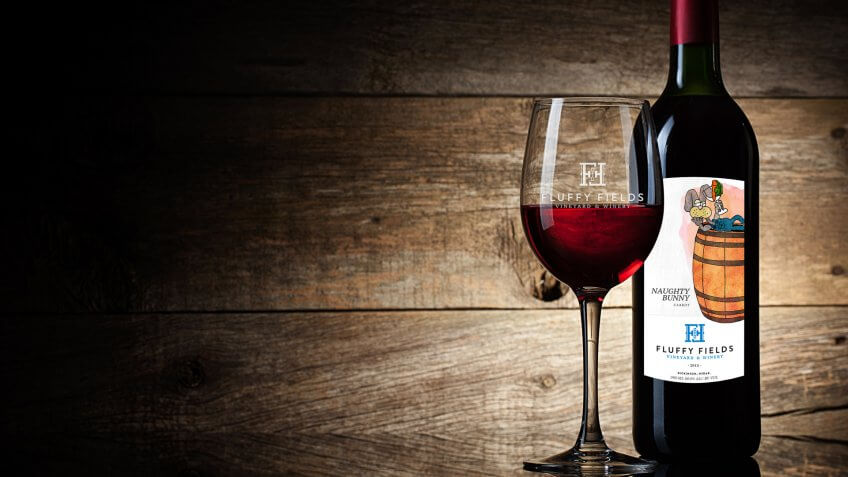 Wine glass and Bottle on a wooden background.