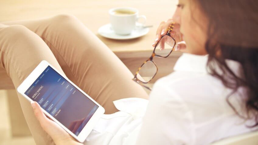 Businesswoman reading information about her bank account on the Internet.