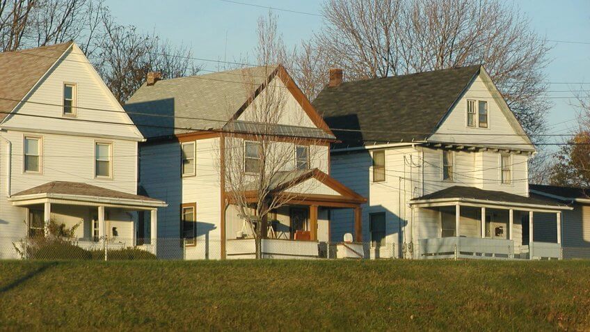 "Three homes in Akron, Ohio as viewed from freeway.