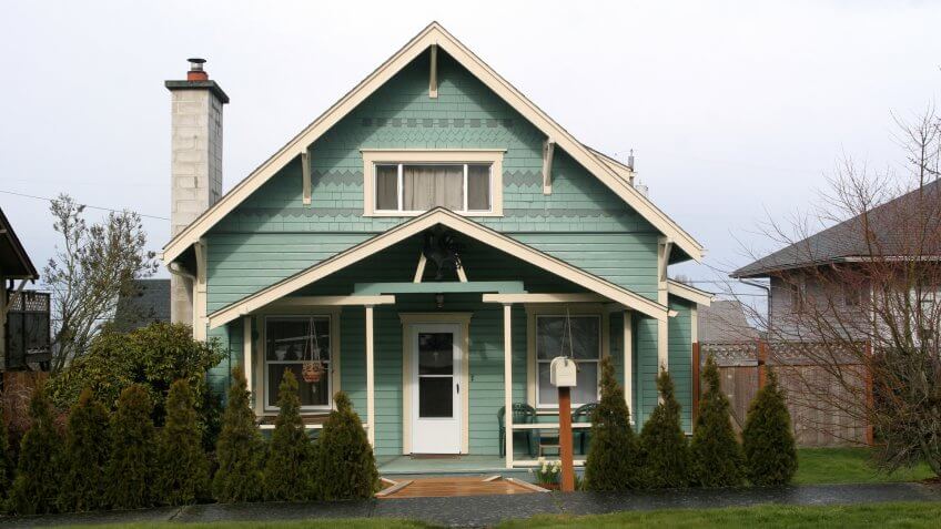 Cute little 50s style bungalow house on city lot.