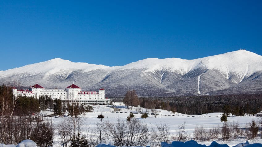 Scenic view of snow covered mountain and lodge at Mount Washington.