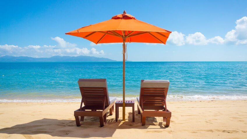 beach chairs under an umbrella