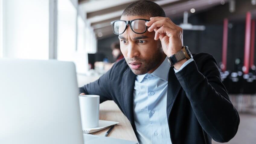 shocked man looking at computer screen