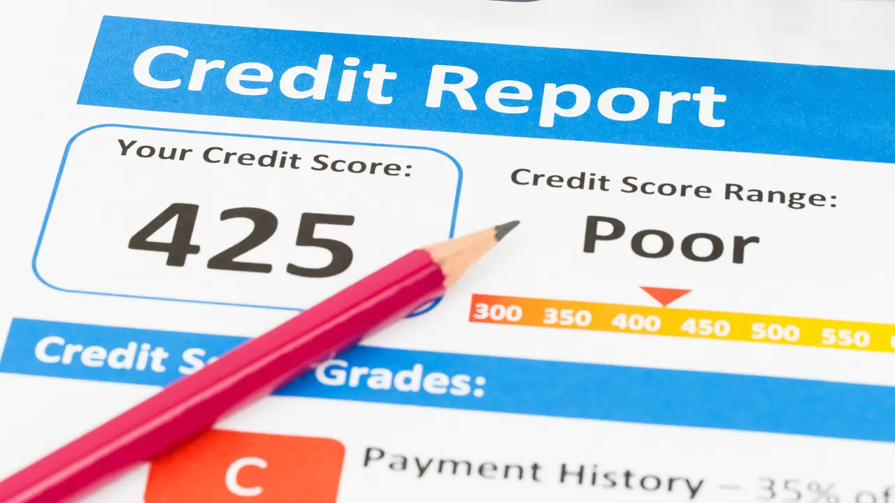 close up of pencil on top of credit report credit score range poor