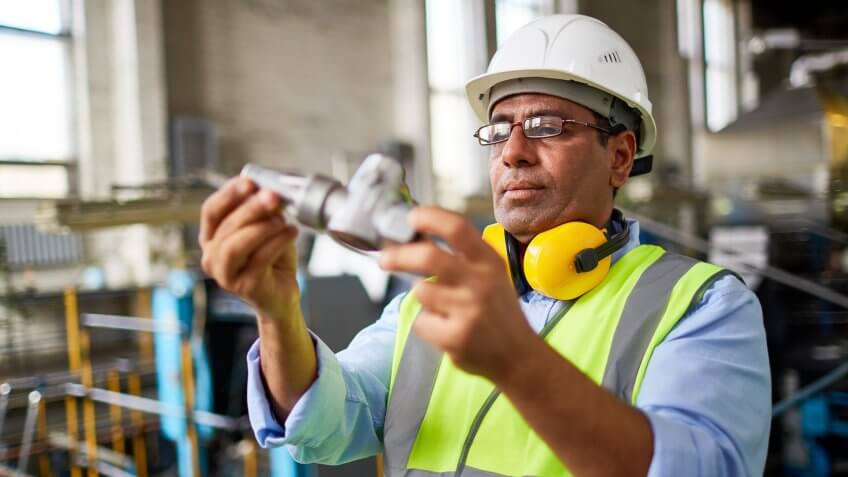 Manufacturing engineer examining pipe