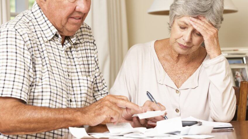 Senior Couple Concerned About Debt Going Through Bills Together.