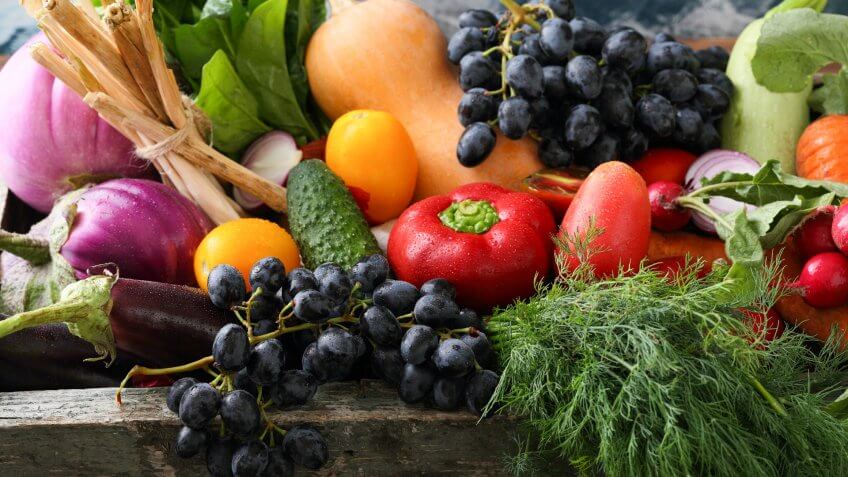 Fresh organic produce in wood crate, food.