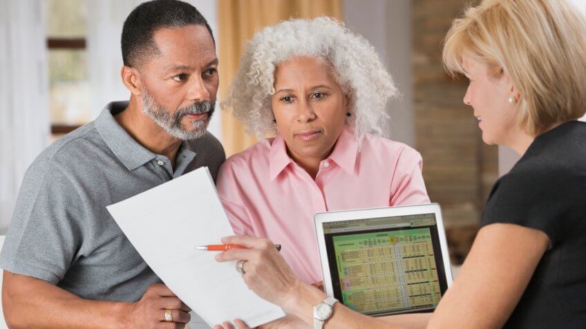 Older couple consulting with financial planner.