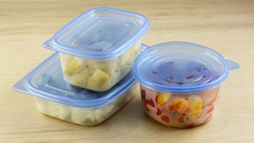 Chopped dinner ingredients of cauliflower, potatoes and cherry tomatoes in plastic refrigerator storage containers prepared in advance for quicker cooking during week after work.