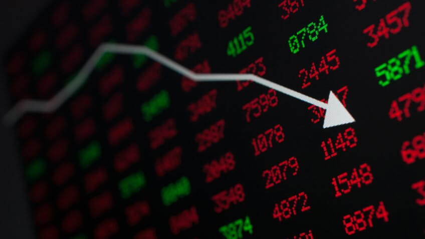Stock Market - Arrow Graph Going Down on Display With Red and Green Figures.