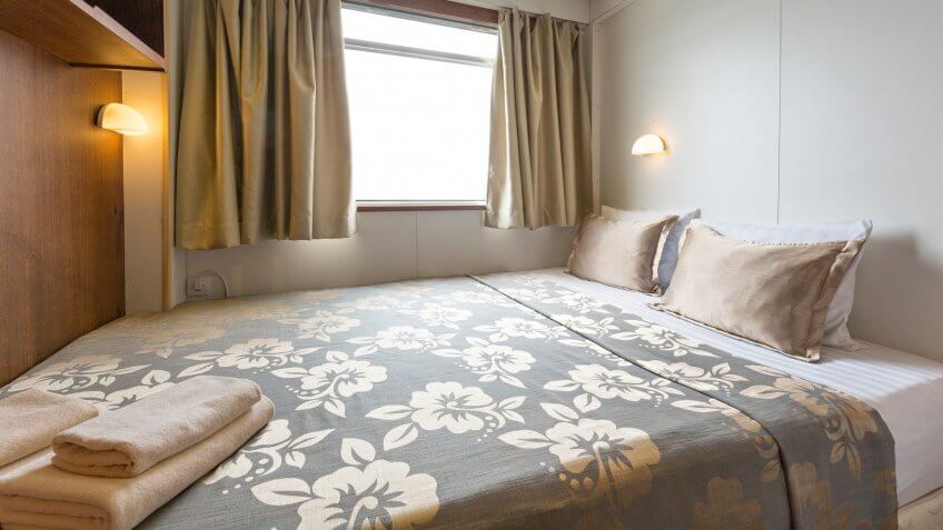 Interior of a cabin bedroom on cruise boat hotel.