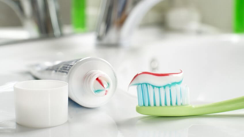 Toothbrushe and toothpaste in the bathroom close up.