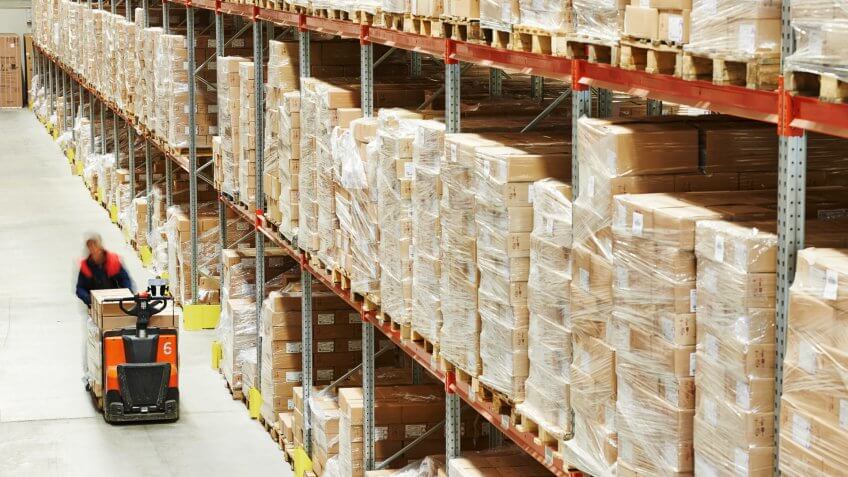 Electric forklift pallet stacker truck equipment at work in warehouse