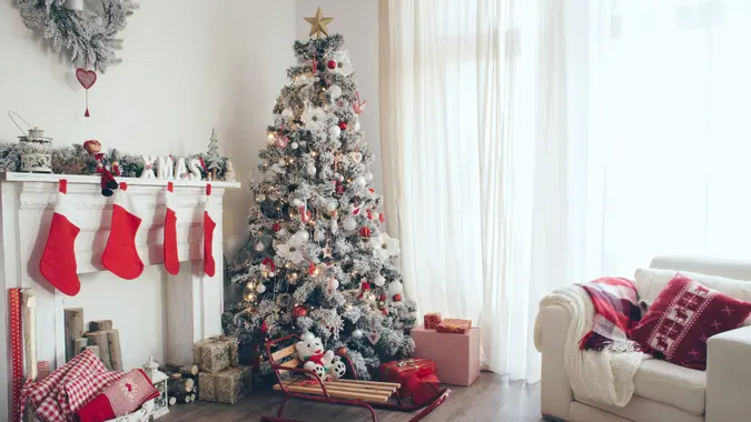 Beautiful holdiay decorated room with Christmas tree with presents under it.