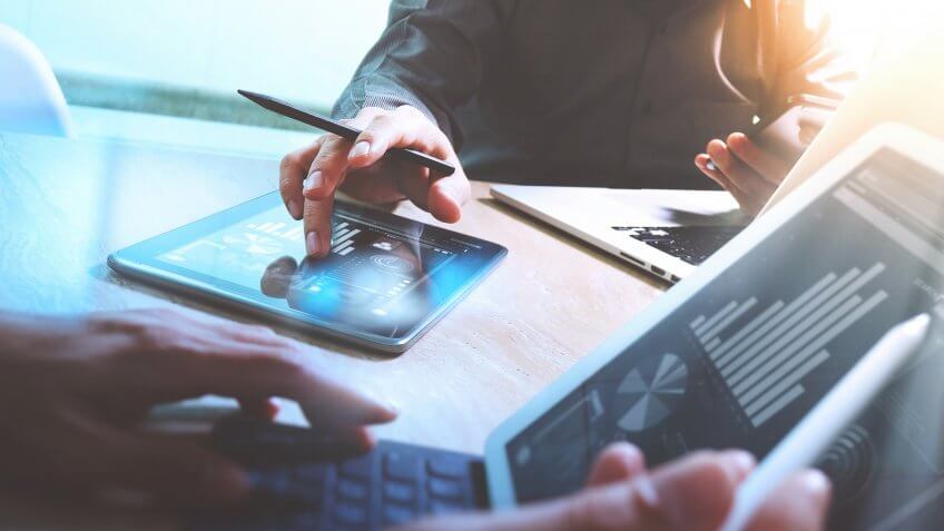 stock charts on tablet and laptop