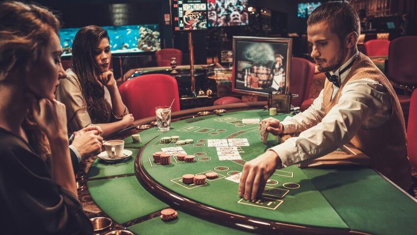 dealer at table with poker players