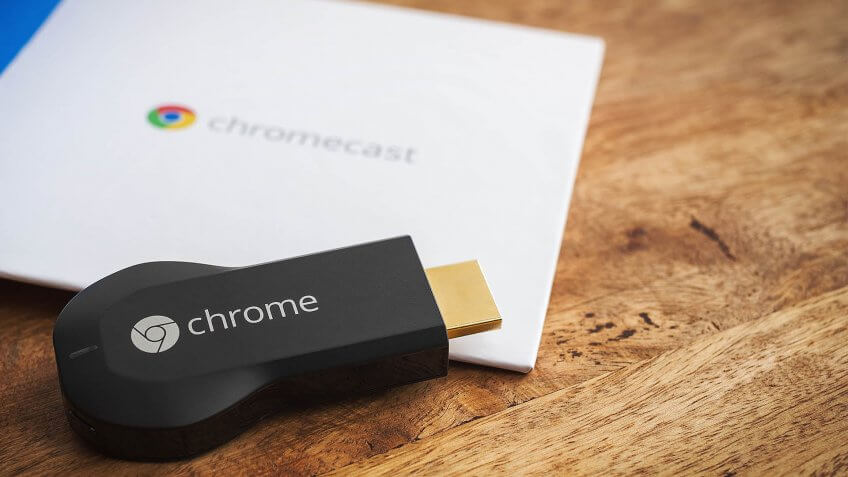 VIENNA, AUSTRIA, 10 May 2014: Google Chromecast HDMI-Dongle on a wooden surface with parts of its original packaging.
