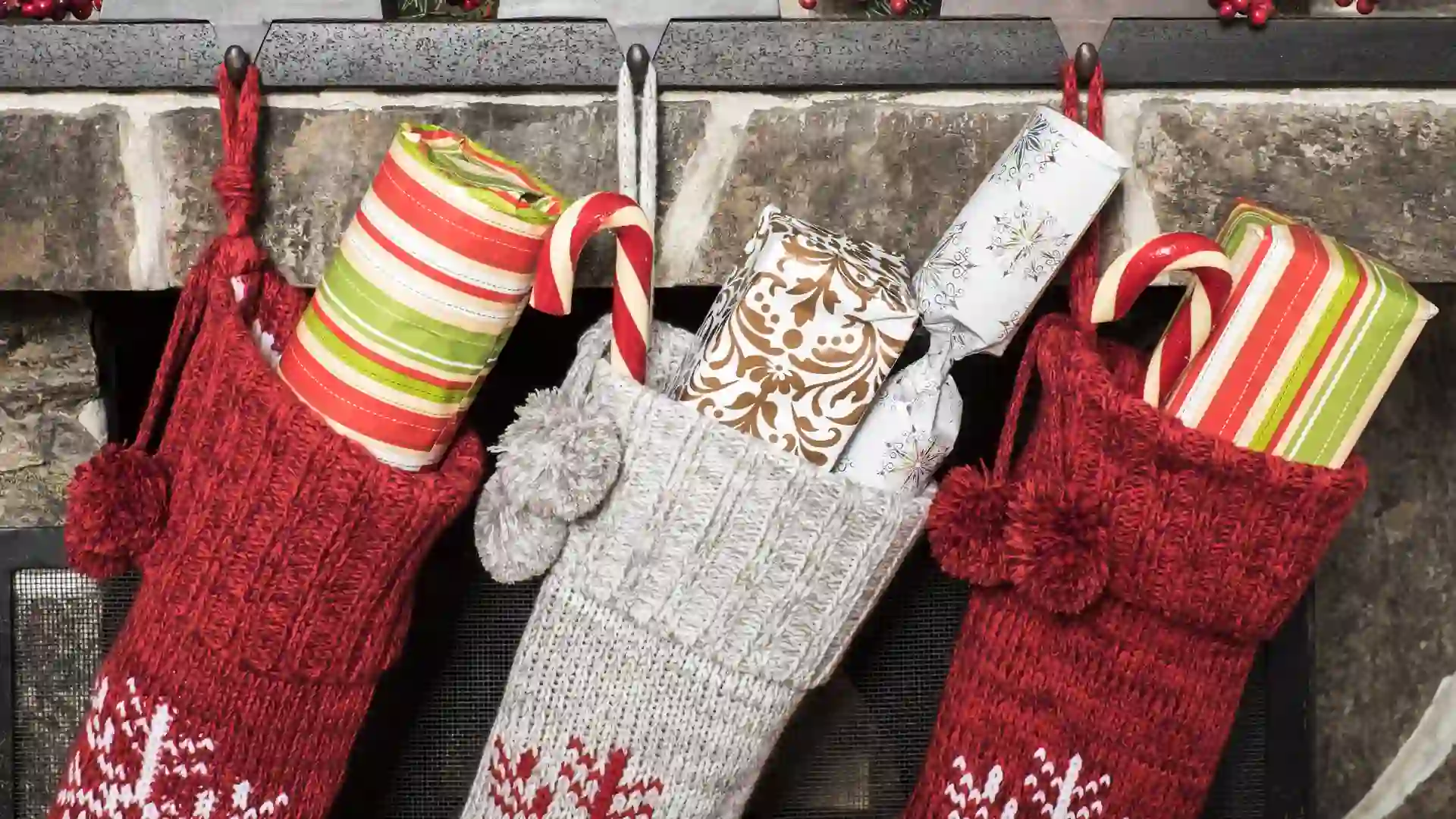 Stuffed stockings hanging on a fireplace on christmas morning.