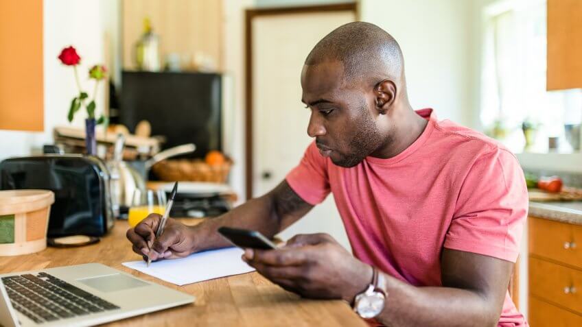 computer programmer working from home in the kitchen