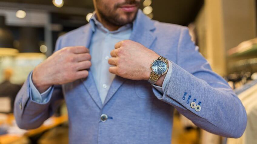 man-trying-on-suit-and-watch