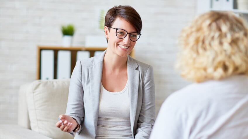 Successful psychologist talking to her patient.