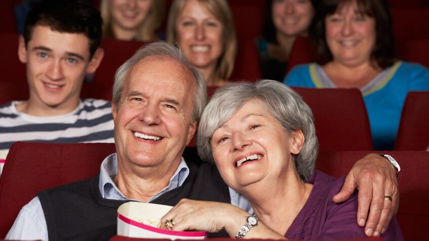Senior Couple Watching Film In Cinema