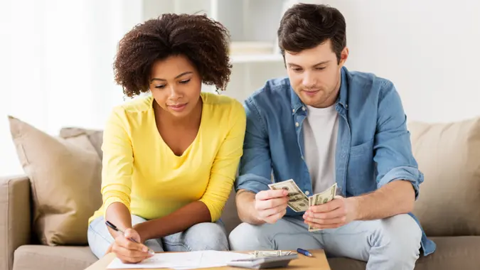bills, couple, multiracial