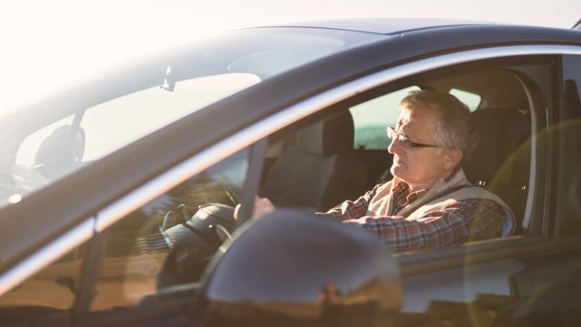 Senior man driving a car.
